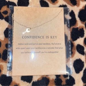 Gold necklace with key charm on it. Cute message on packaging.